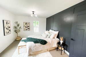 Bedroom featuring light carpet