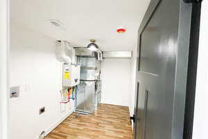 Utility room featuring tankless water heater