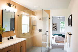 Bathroom with vanity, tile patterned floors, a wealth of natural light, and an enclosed shower