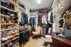 Walk in closet with carpet floors