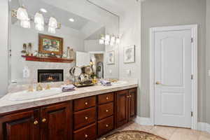 Bathroom with dual vanity and tile patterned floors