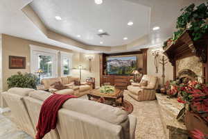 Living room with tile patterned floors, a raised ceiling, and a textured ceiling