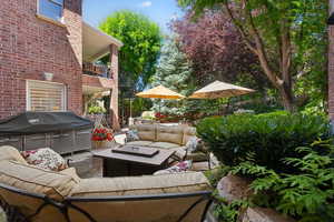 View of patio / terrace featuring a balcony, grilling area, and an outdoor living space with a fire pit