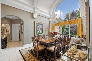 Tiled dining area with a chandelier