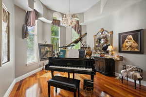 Misc room featuring an inviting chandelier and hardwood / wood-style floors