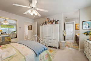 Bedroom featuring ceiling fan and light colored carpet