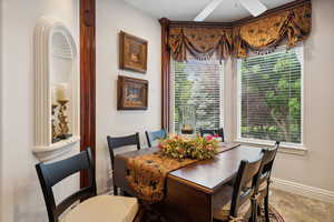 Dining area with tile patterned flooring and ceiling fan