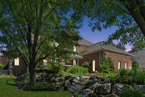 View of front of house with a lawn and central AC unit