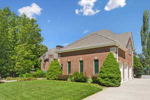 View of front of house featuring a garage and a front lawn