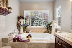 Bathroom with vanity and a relaxing tiled tub