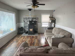 Spacious Family room featuring ceiling fan, hardwood / wood-style flooring, and a wood stove