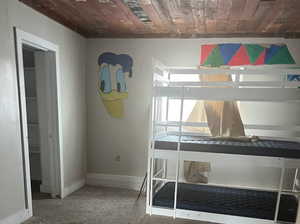 bedroom with carpet floors and wooden ceiling