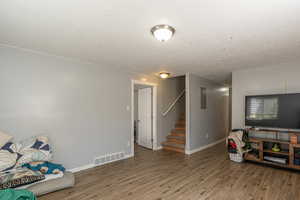 Rec room featuring a textured ceiling and hardwood / wood-style floors