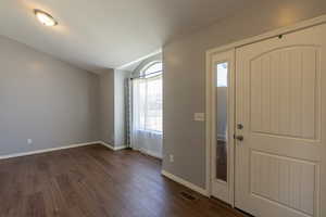 Entrance foyer with dark hardwood / wood-style floors