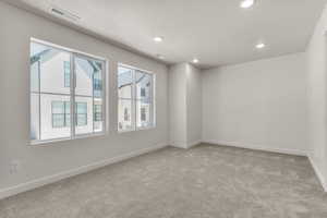 Empty room featuring carpet floors and a textured ceiling