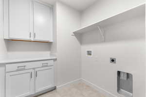 Laundry area featuring cabinets, hookup for an electric dryer, and washer hookup