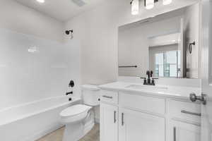 Full bathroom featuring tile patterned flooring,  shower combination, toilet, and vanity