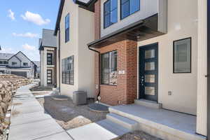 Entrance to property featuring central AC