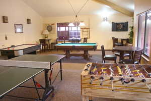 Game room featuring carpet floors, lofted ceiling with beams, and billiards