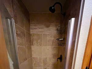 Bathroom featuring tiled shower