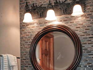 Bathroom featuring vanity and backsplash