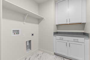 Washroom featuring washer hookup, light tile patterned flooring, electric dryer hookup, and cabinets