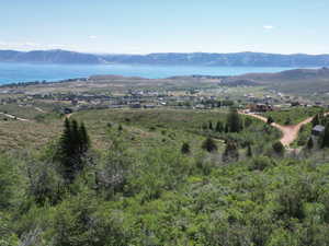 Birds eye view of property with a water and mountain view