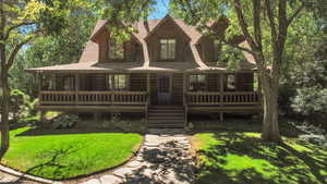 Log-style house featuring a front yard