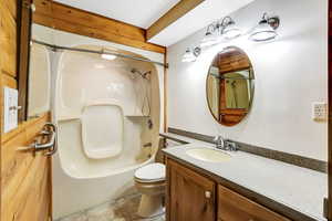 Full bathroom featuring shower / bathtub combination, toilet, vanity, and tile patterned flooring