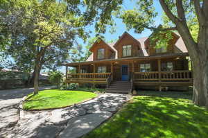 Log-style house featuring a front lawn