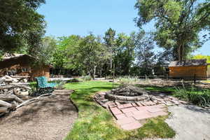 View of yard with an outdoor fire pit