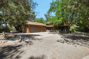 View of  back of house with a large two car garage