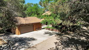 View of property exterior featuring a heated extra wide detached two-car garage