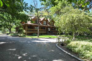 Log cabin featuring covered porch