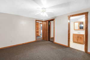 Unfurnished bedroom with a closet, ensuite bath, sink, light carpet, and ceiling fan