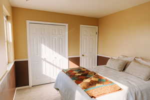 Bedroom featuring carpet flooring and multiple windows