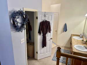 Primary Bathroom featuring double vanity and primary closet