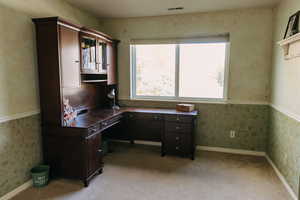 Carpeted office space featuring a wealth of natural light