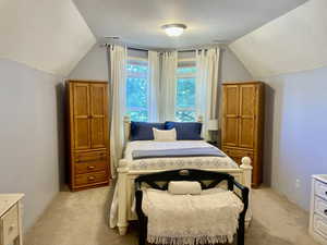 Primary Bedroom Carpeted with lofted ceiling