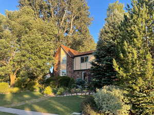 View of side of home featuring a lawn