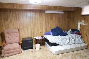 Bedroom featuring carpet floors, wood walls