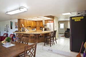 Dining area with sink and light tile patterned floors