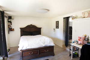 Bedroom featuring a textured ceiling and hardwood / wood-style flooring