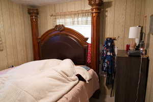 Bedroom with wooden walls