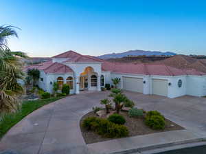 Mediterranean / spanish-style home with a garage