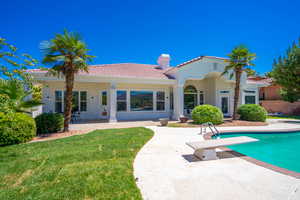 Back of property with a patio and a yard