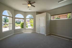 Front Office / 2nd Bedroom carpeted empty room with a textured ceiling and ceiling fan