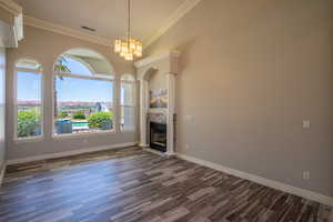 Front Formal LR with a fireplace, a chandelier, dark hardwood / wood-style flooring, and ornamental molding