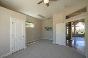 2nd Bedroom Carpeted spare room with a wealth of natural light and ceiling fan with notable chandelier