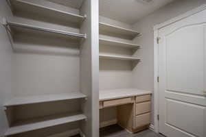 Spacious closet featuring built in desk